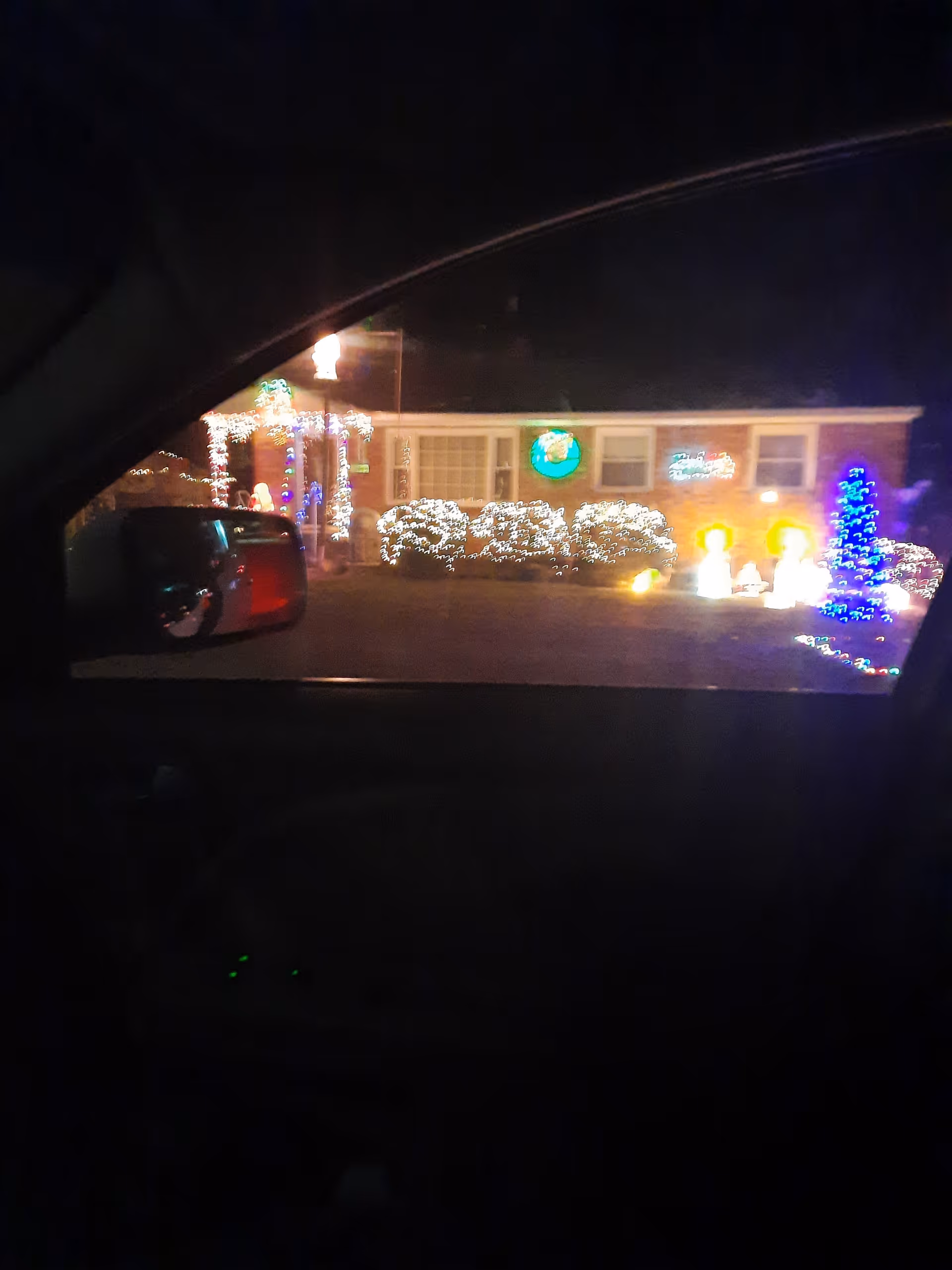 Night view of Caring Hearts facility with festive holiday lights decorating the front entrance.