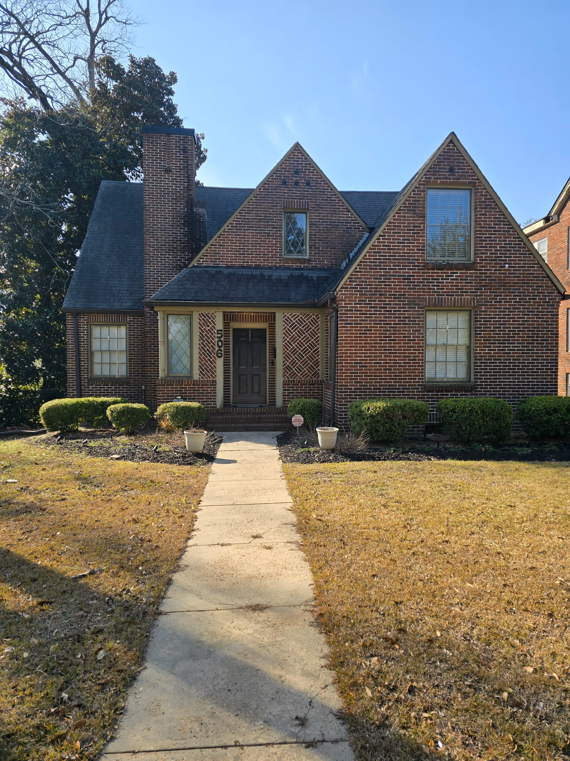 Brick-faced senior living home with a central walkway leading to the front door.