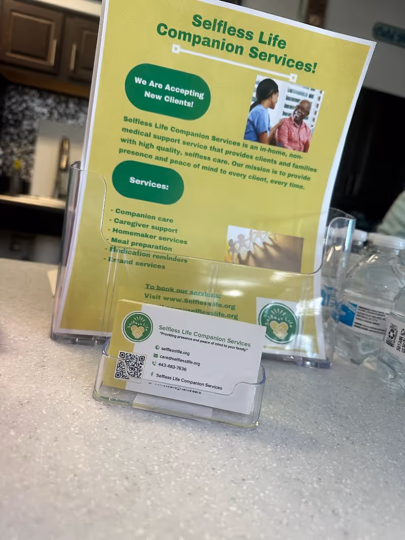 Bright yellow Selfless Life brochure on a countertop inside a kitchen-like interior.