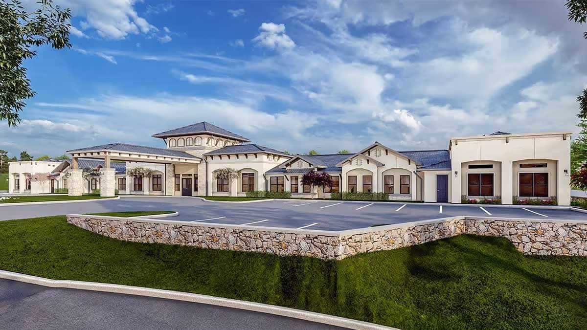 Front exterior of The Emberly at Heritage Glen senior living center with parking and landscaped grounds.