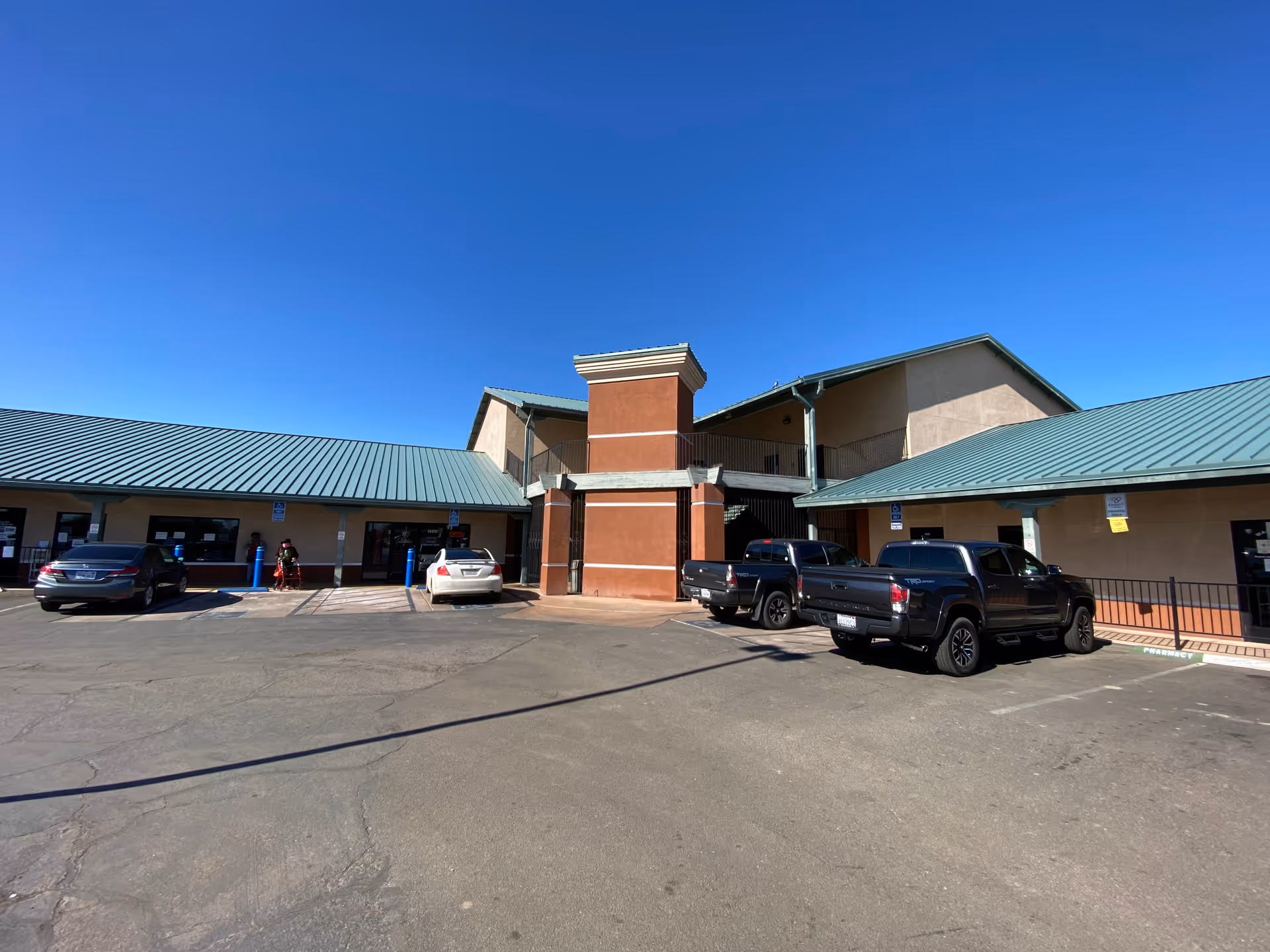 Front exterior view of Uni Care Home Care facility with cars in parking lot.