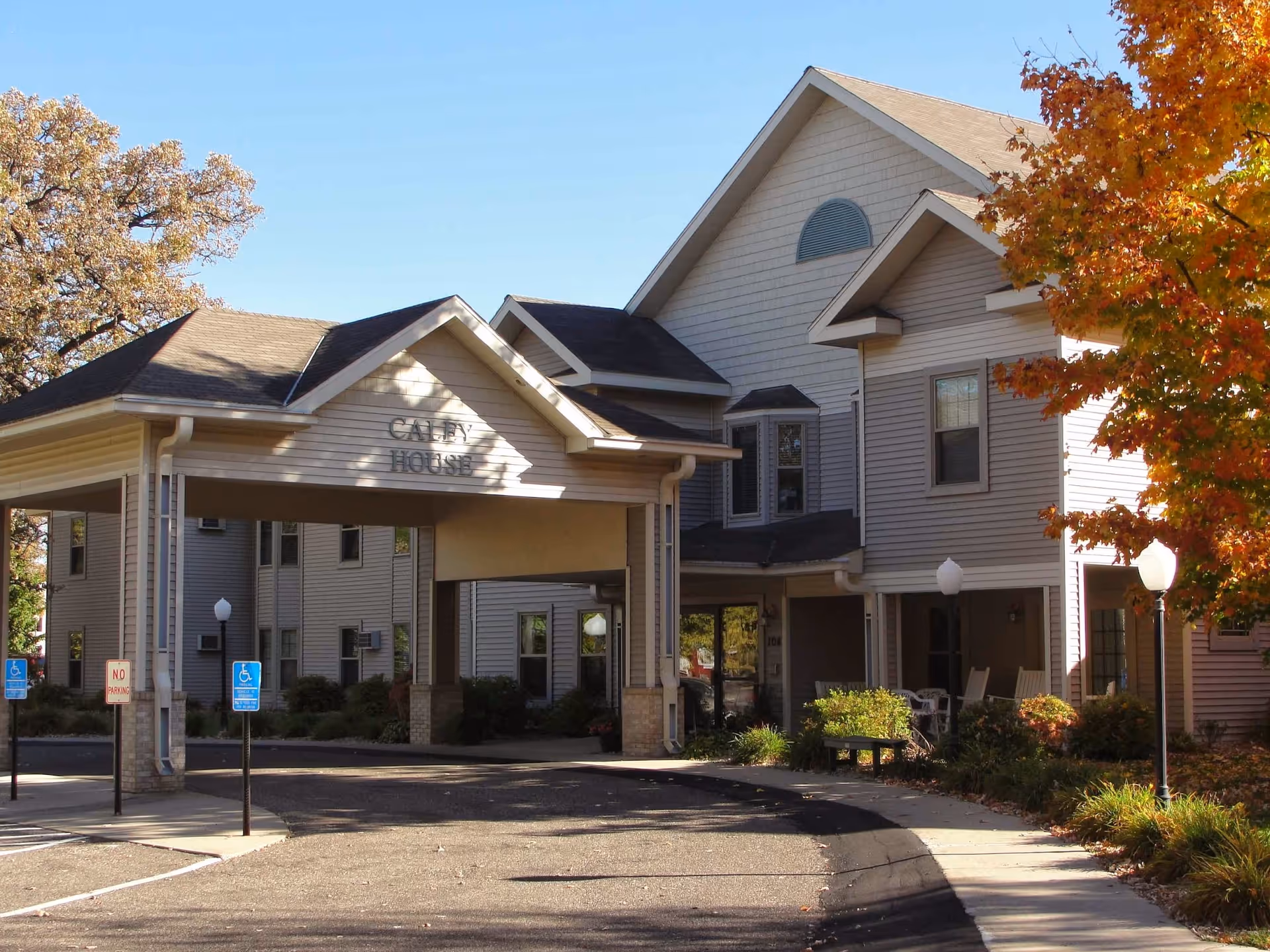 Exterior view of Caley House senior living facility, showing the front entrance and surrounding parking.