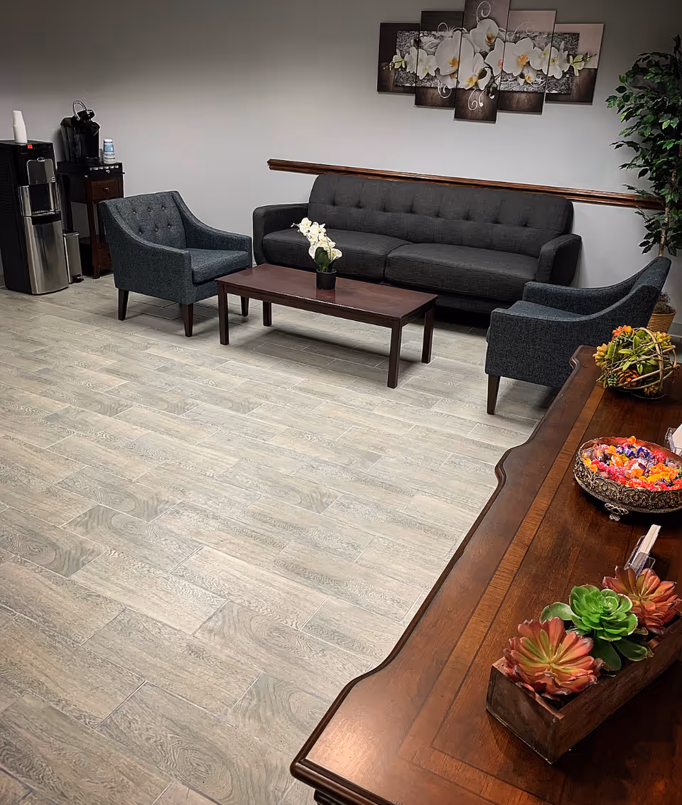Interior lounge area with sofa, chairs, coffee table, and wall art.