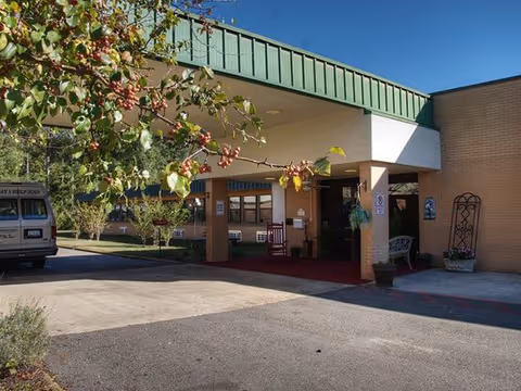 Exterior view of Azalea Health and Rehab entrance with a covered drop-off area.