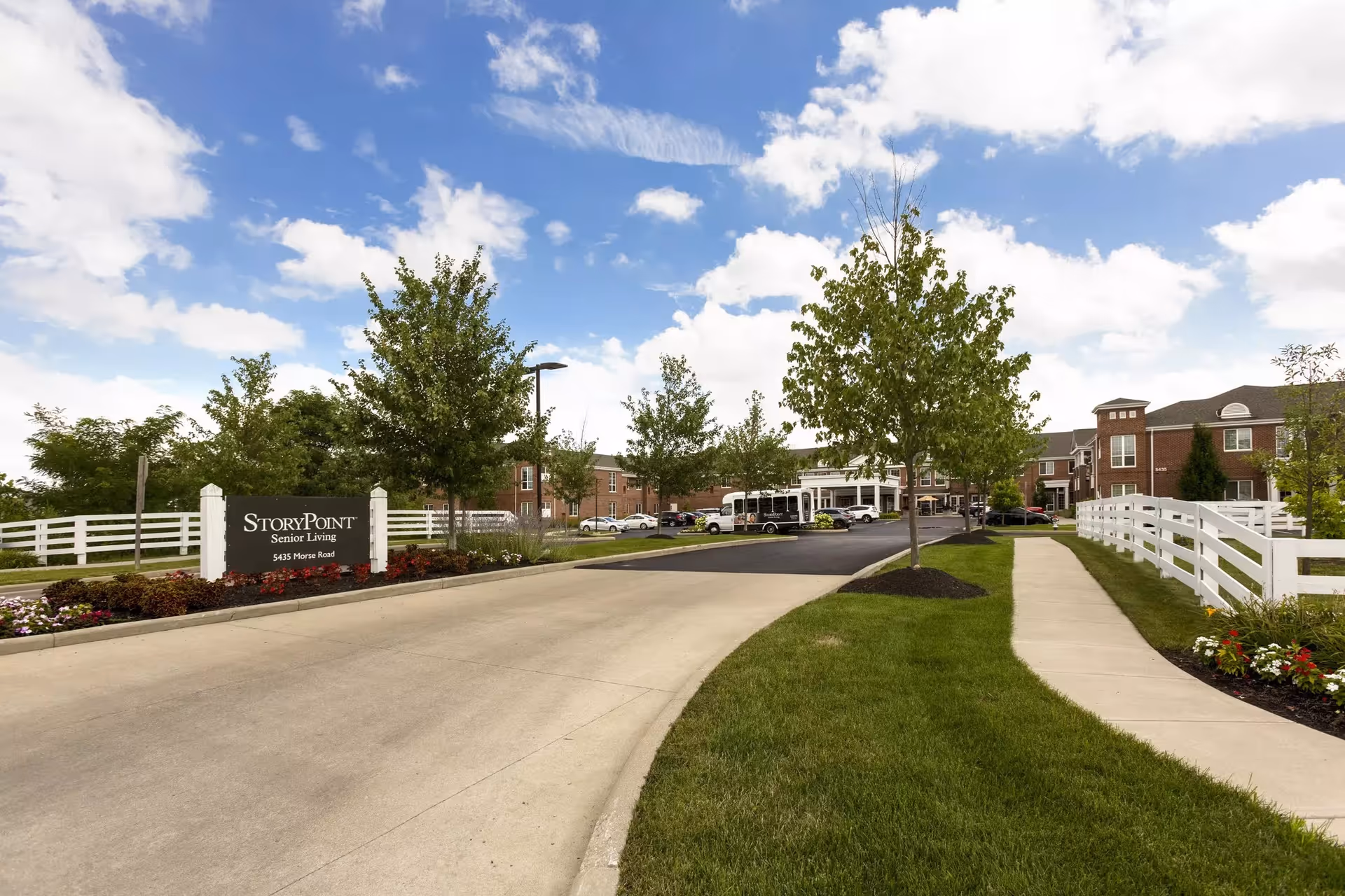 Wide shot of StoryPoint Gahanna North's front entrance with drive, lawn, and sign.