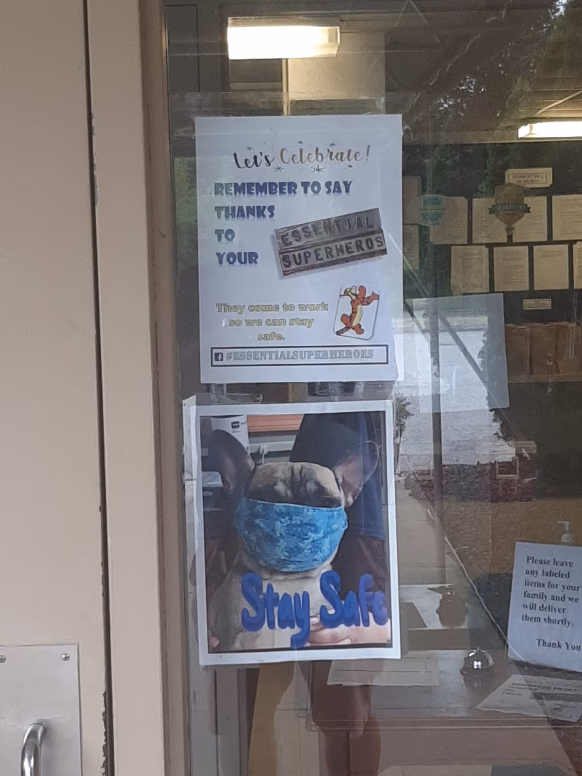 Entrance door at Pierce Care with safety posters and a 'Stay Safe' sign.