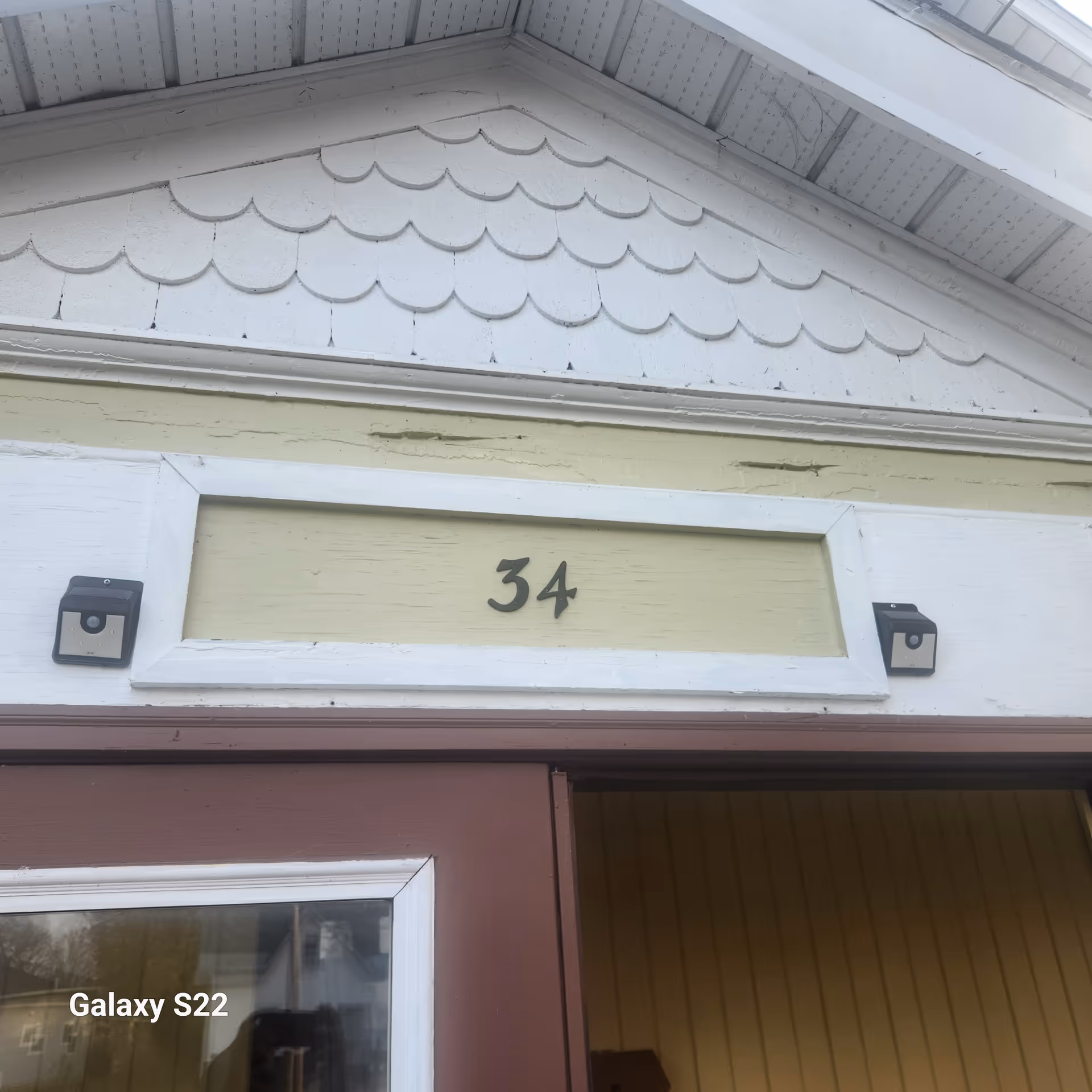 Exterior building front with address 34 and decorative scalloped shingles