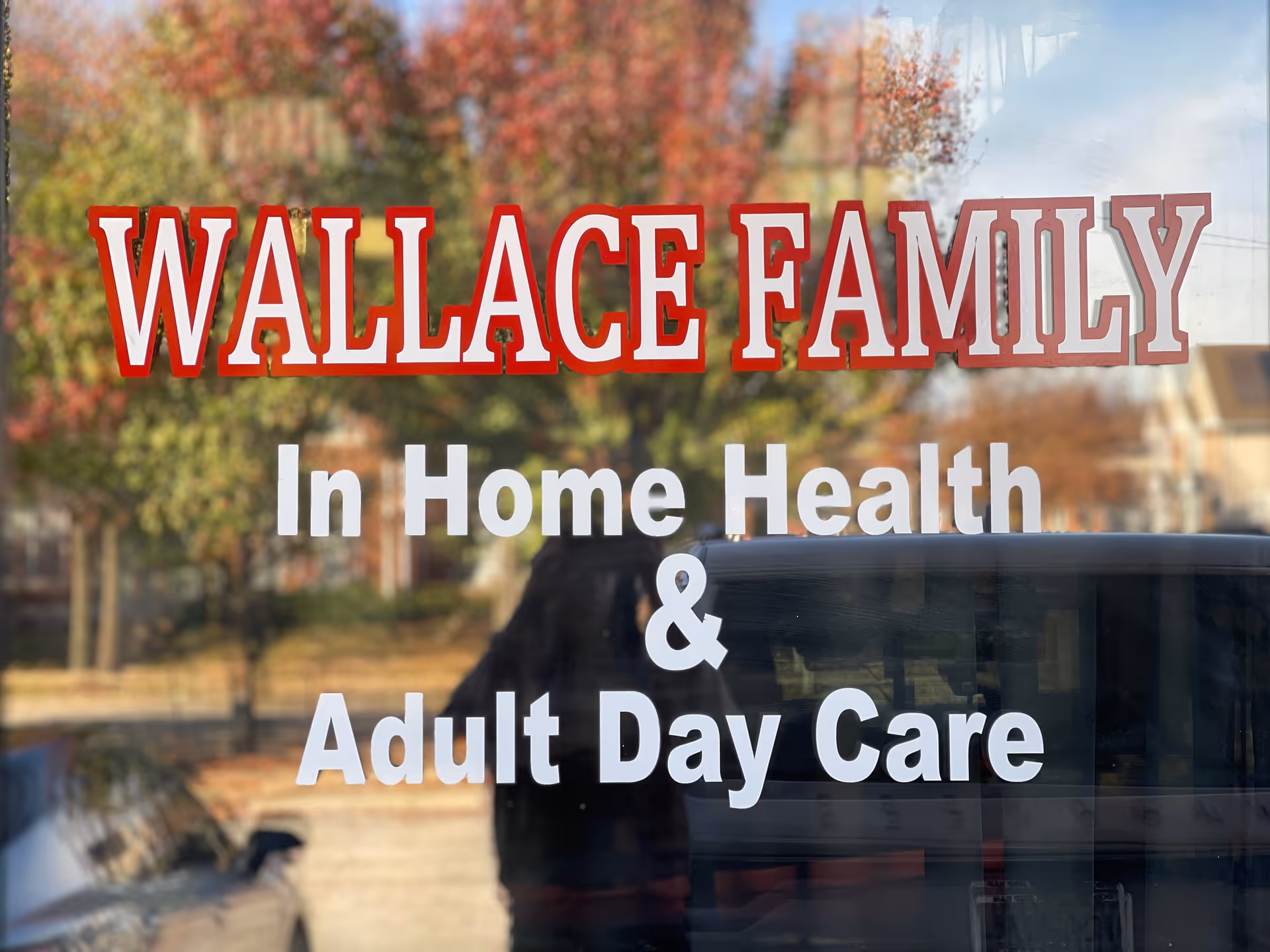 Sign on building window reads Wallace Family In Home Health & Adult Day Care