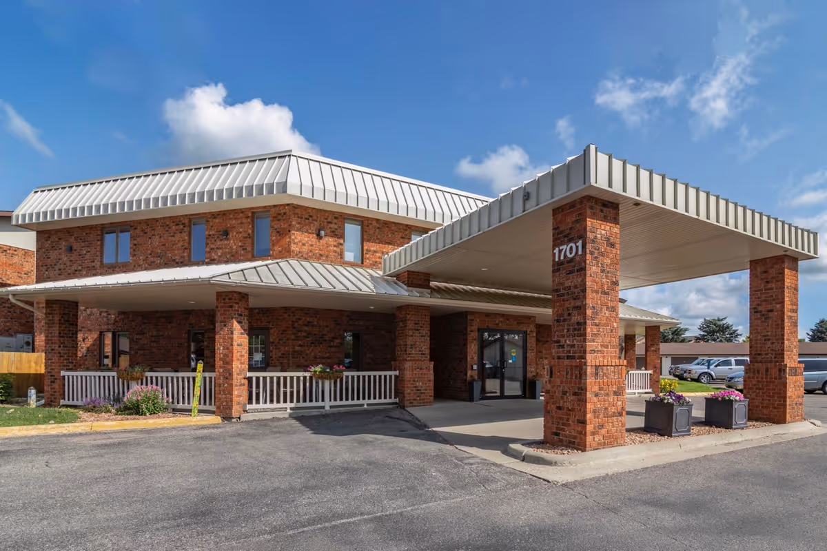 Exterior view of Derian Lodge Senior Living, brick building with a covered front entrance.