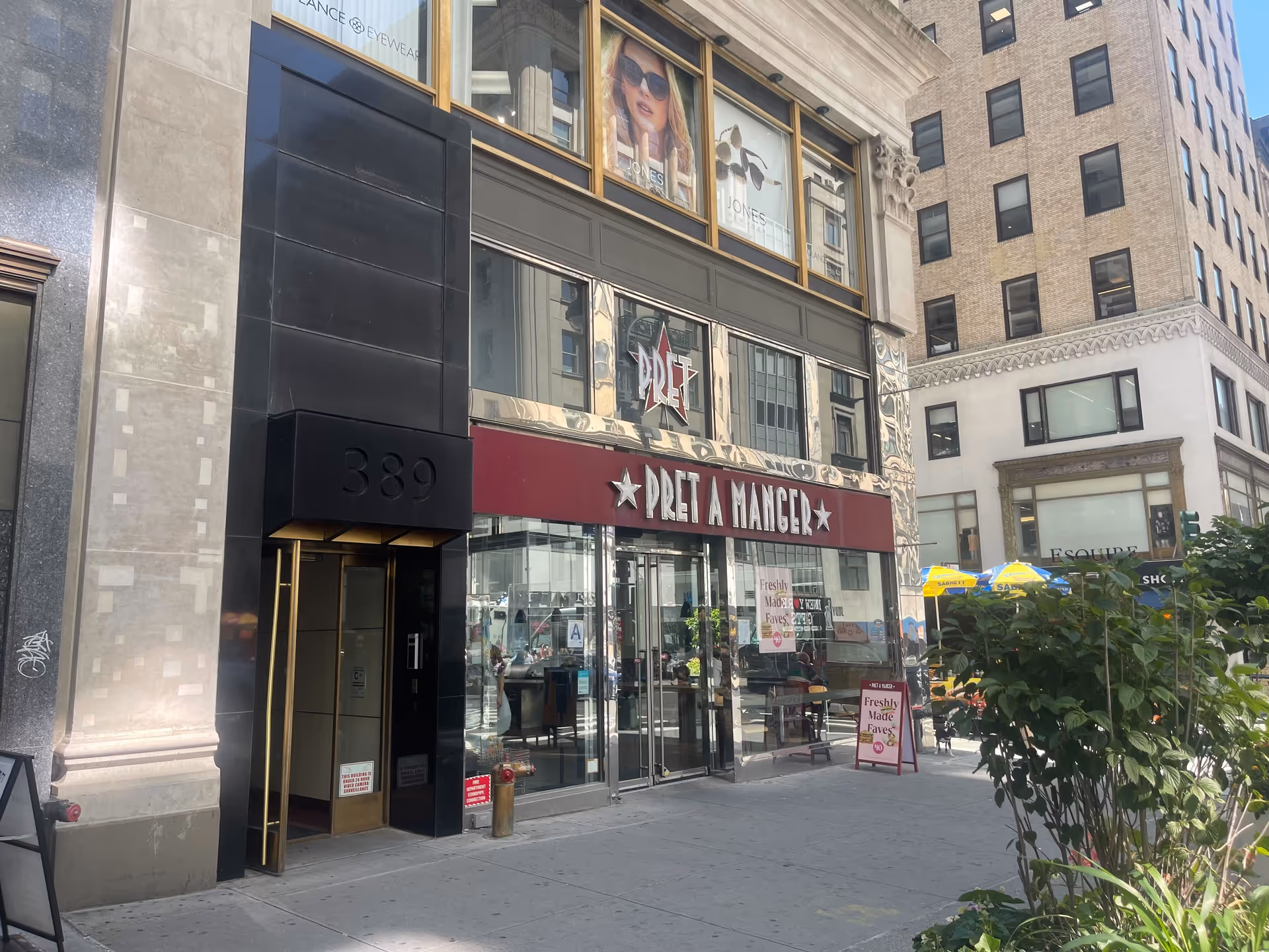 Urban storefront exterior with Pret A Manger sign and glass doors along a city sidewalk.