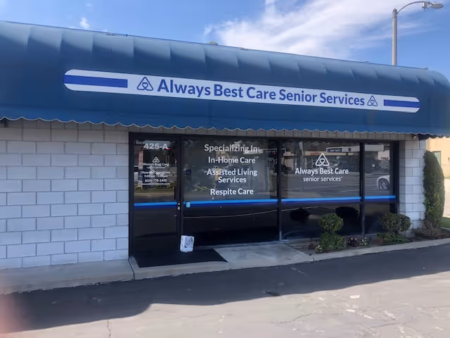 Storefront with blue awning and glass windows advertising Always Best Care Senior Services.