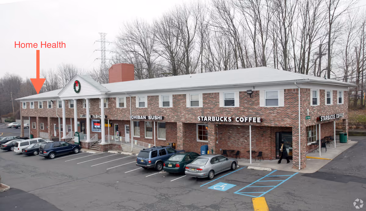 Exterior view of a brick storefront building with Starbucks and a CAREPOINT Home Health sign.