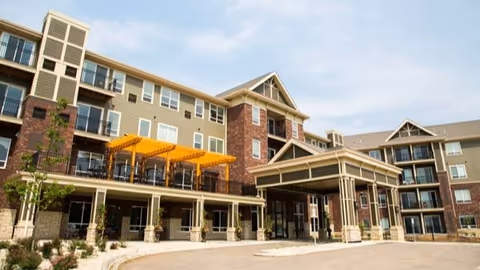 Exterior view of Eagan Pointe Senior Living building with brick façade and a covered entrance.