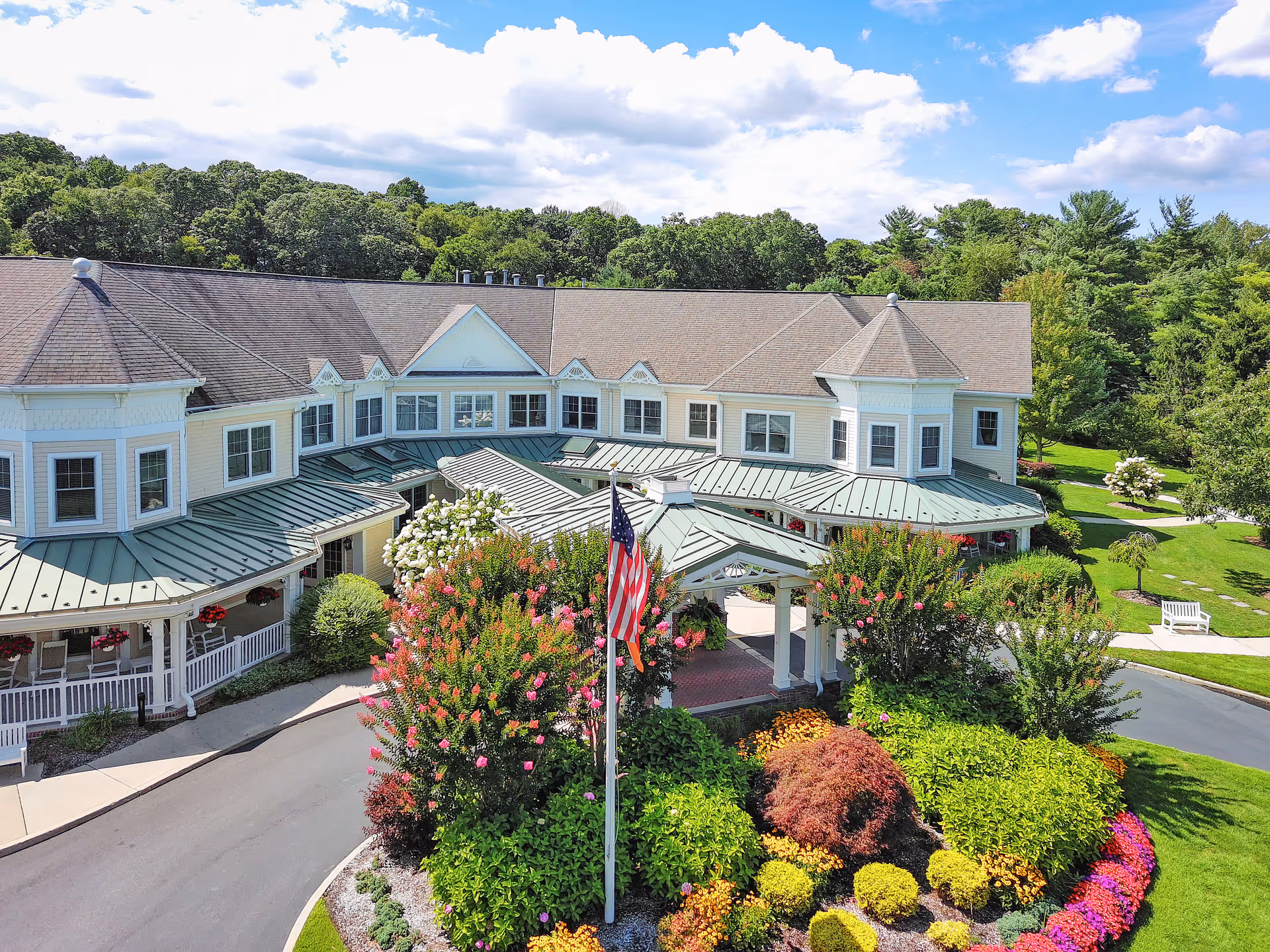 Sunrise of Dix Hills exterior view with landscaped garden and entrance.