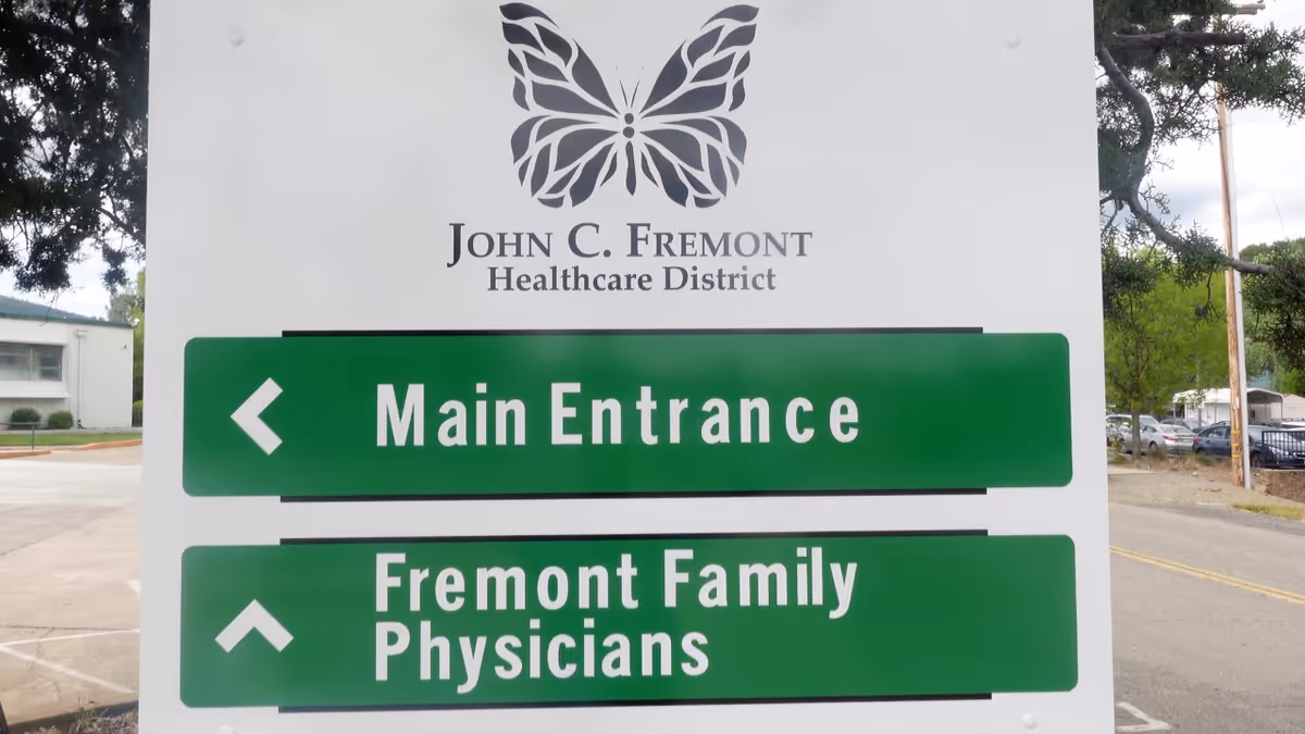 Large outdoor sign for John C. Fremont Healthcare District with Main Entrance arrows.