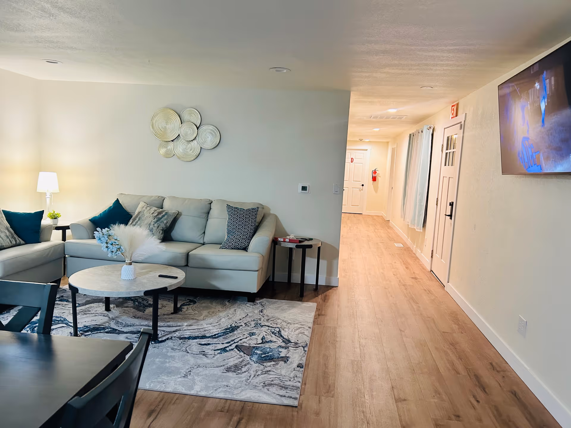 Cozy living room in Charming Care Adult Family Home with sofa and hallway.