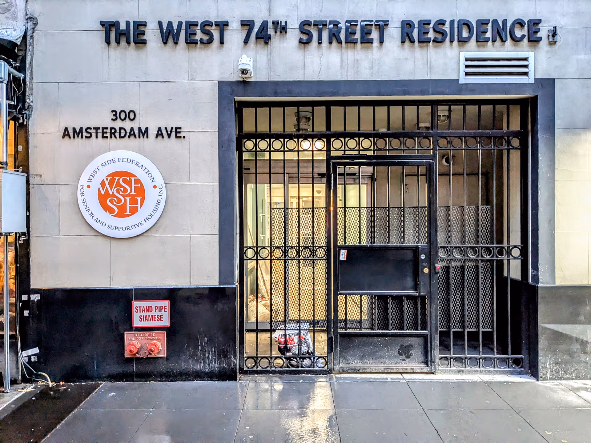 The front entrance of The West 74th Street Residence features a gated doorway.
