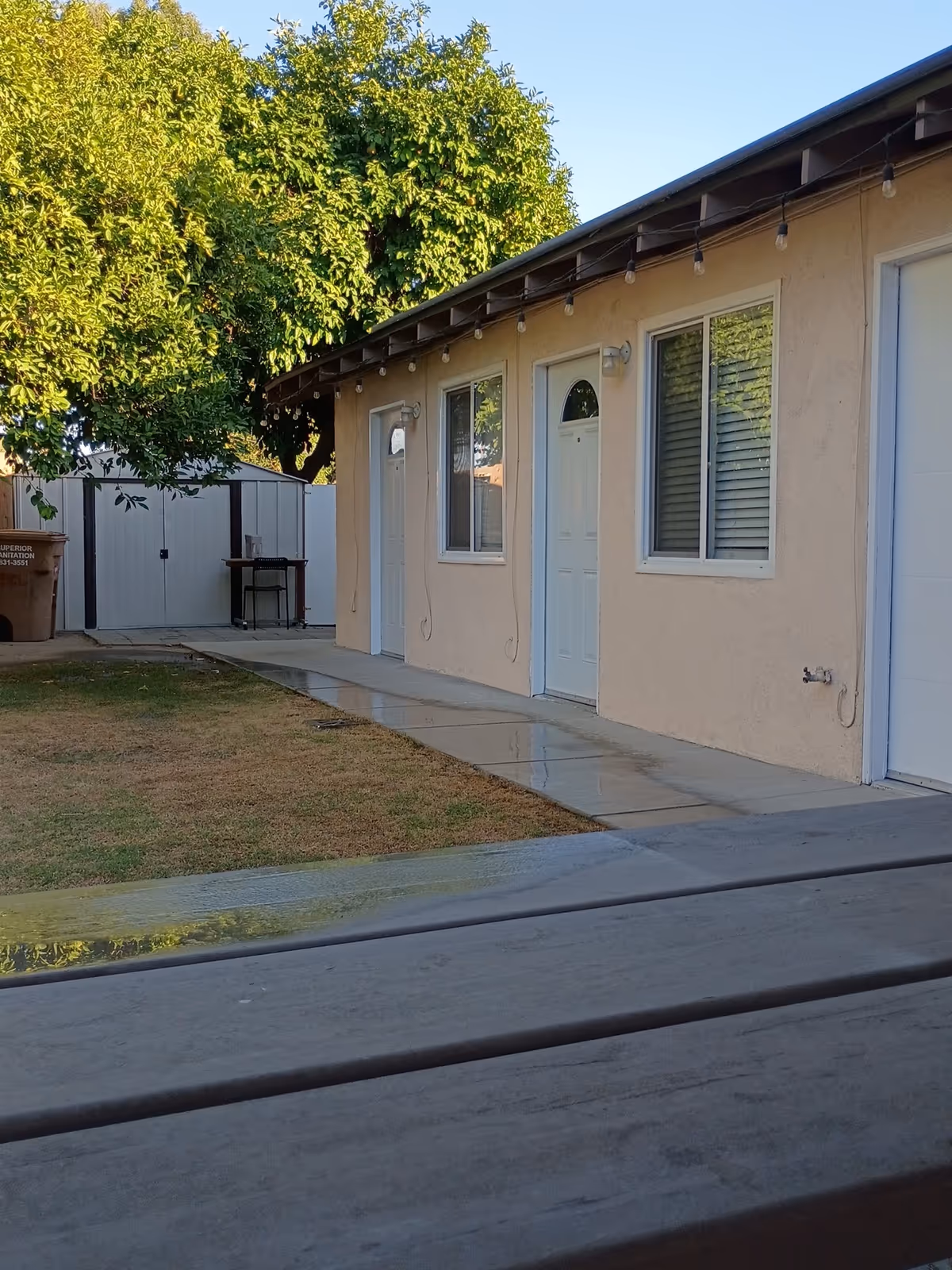 Exterior view of a Parkside Congregate Living building with doors, windows, and string lights.