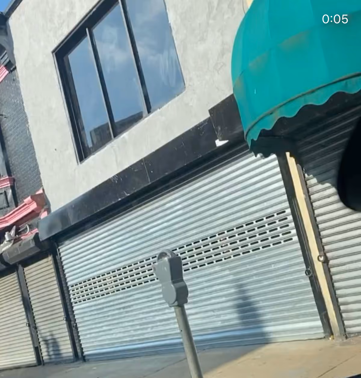 Exterior view of KissessKare HomeCare building with closed metal shutters and a green awning