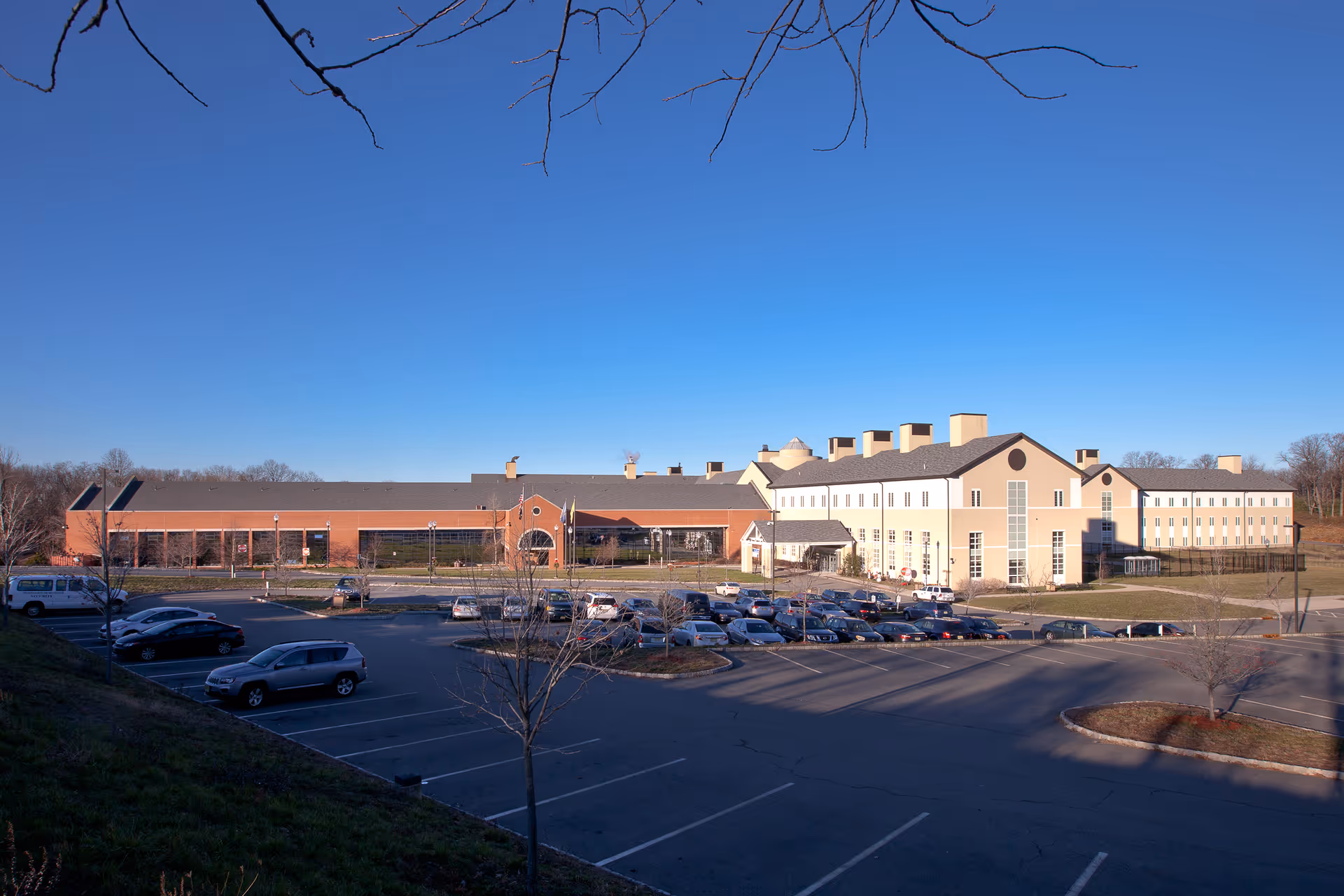 Exterior view of Preakness Healthcare Center with parking lot and clear blue sky