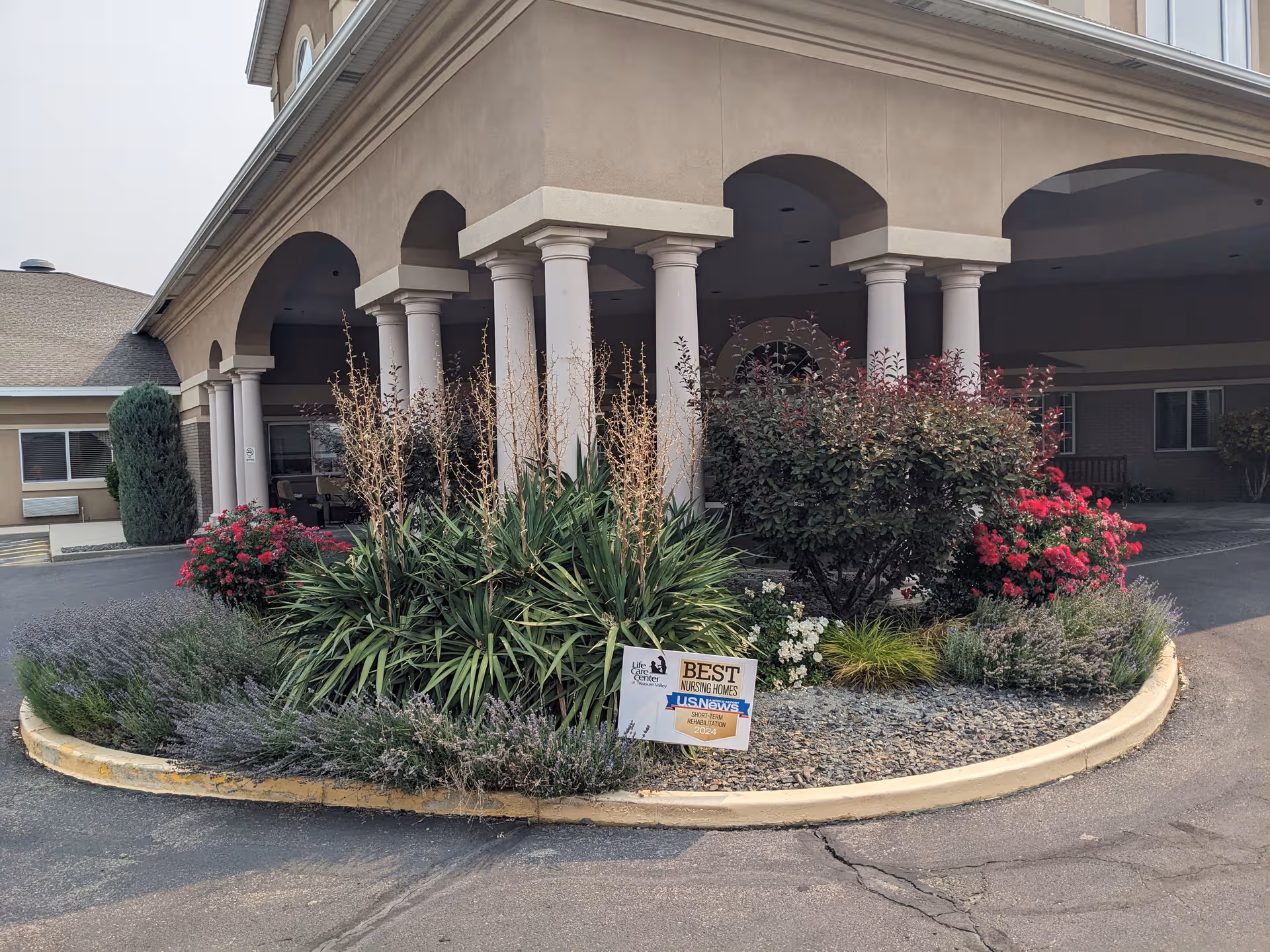 Exterior view of Life Care Center of Treasure Valley entrance with arches and landscaping.