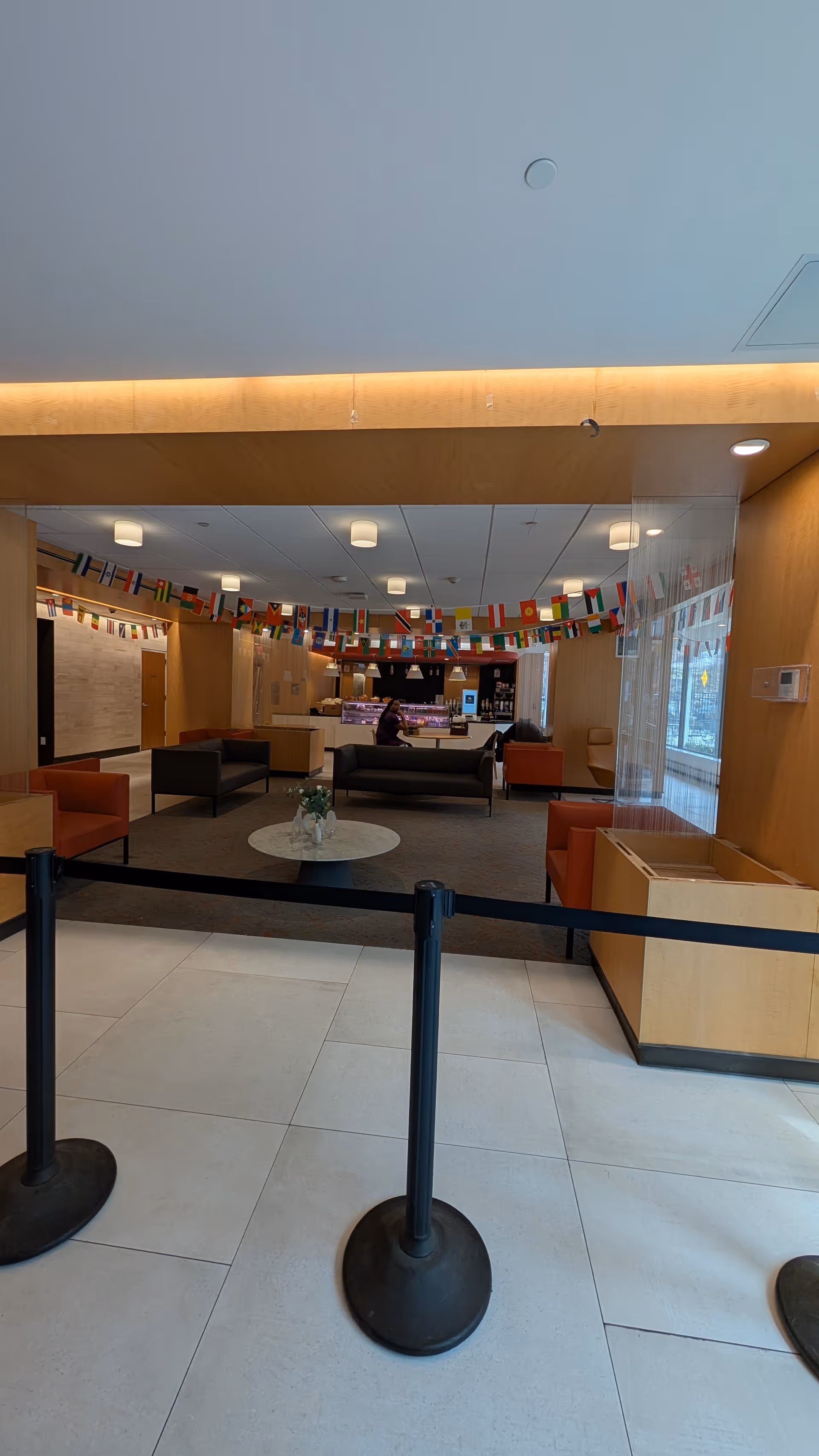 Lobby area at Ditmas Park Nursing and Rehab with seating and international flag banners