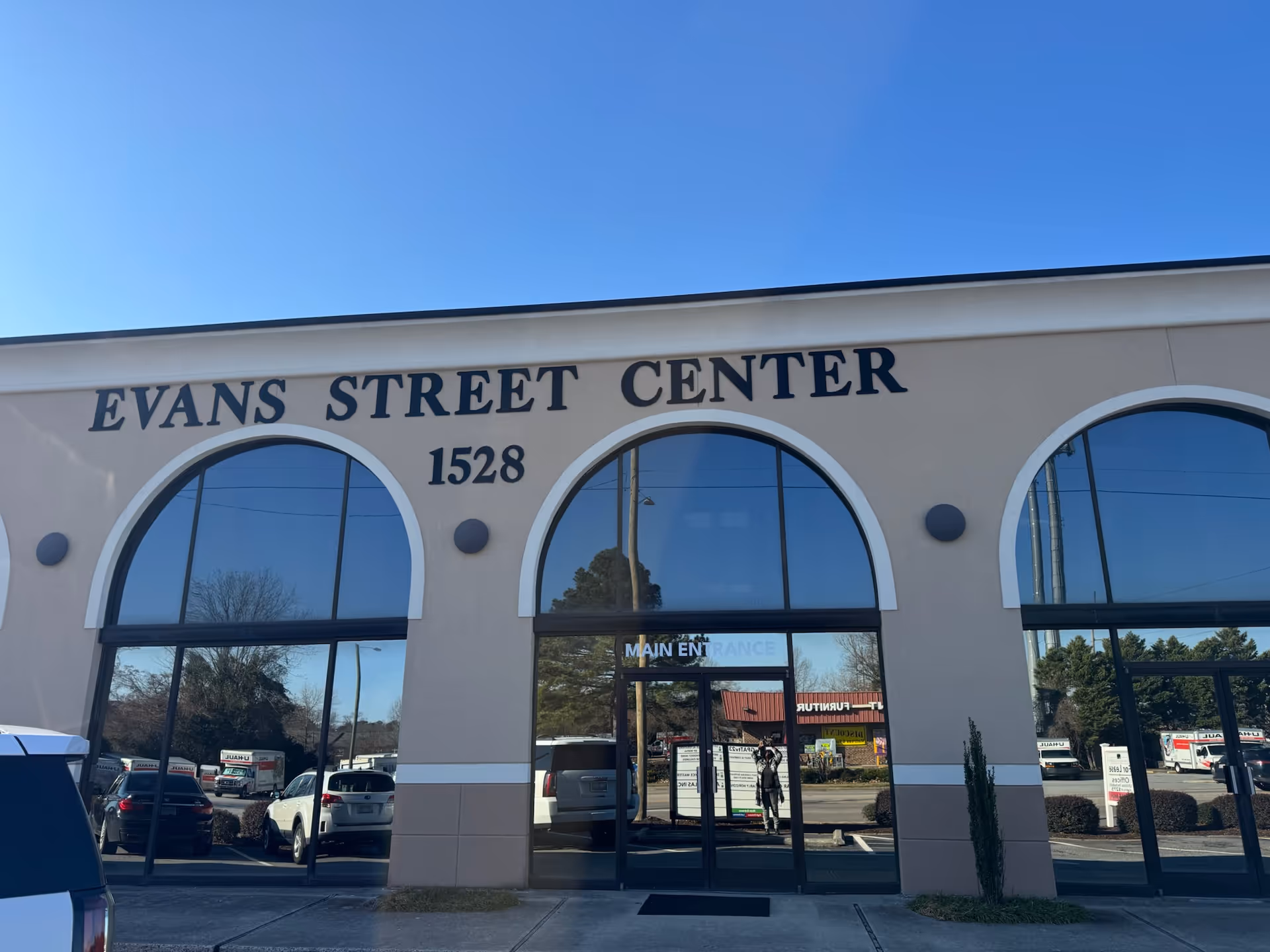 Front view of Evans Street Center with arched windows and glass doors.