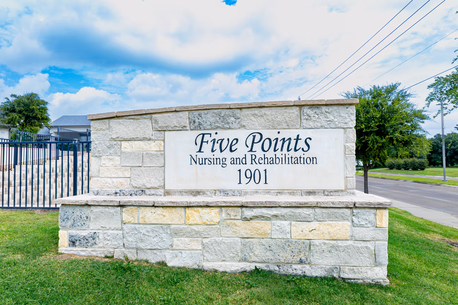 Stone exterior sign reads Five Points Nursing and Rehabilitation at the entrance