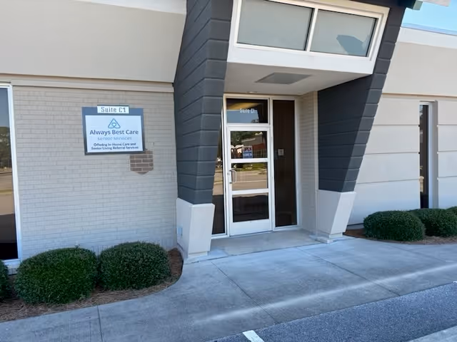 Front entrance of Always Best Care Senior Services building with glass door and sign.