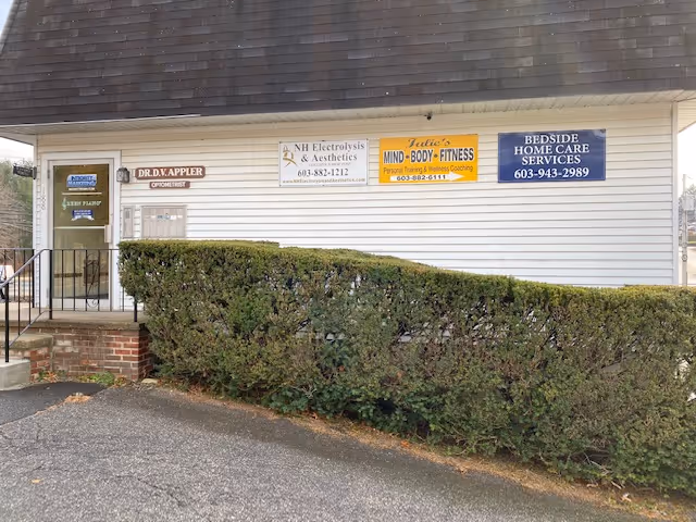 Front of a white building with signs for Bedside Home Care Services.