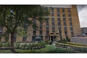 Exterior view of Caring Angels Assisted Living Facility with a brick facade and landscaped entrance.