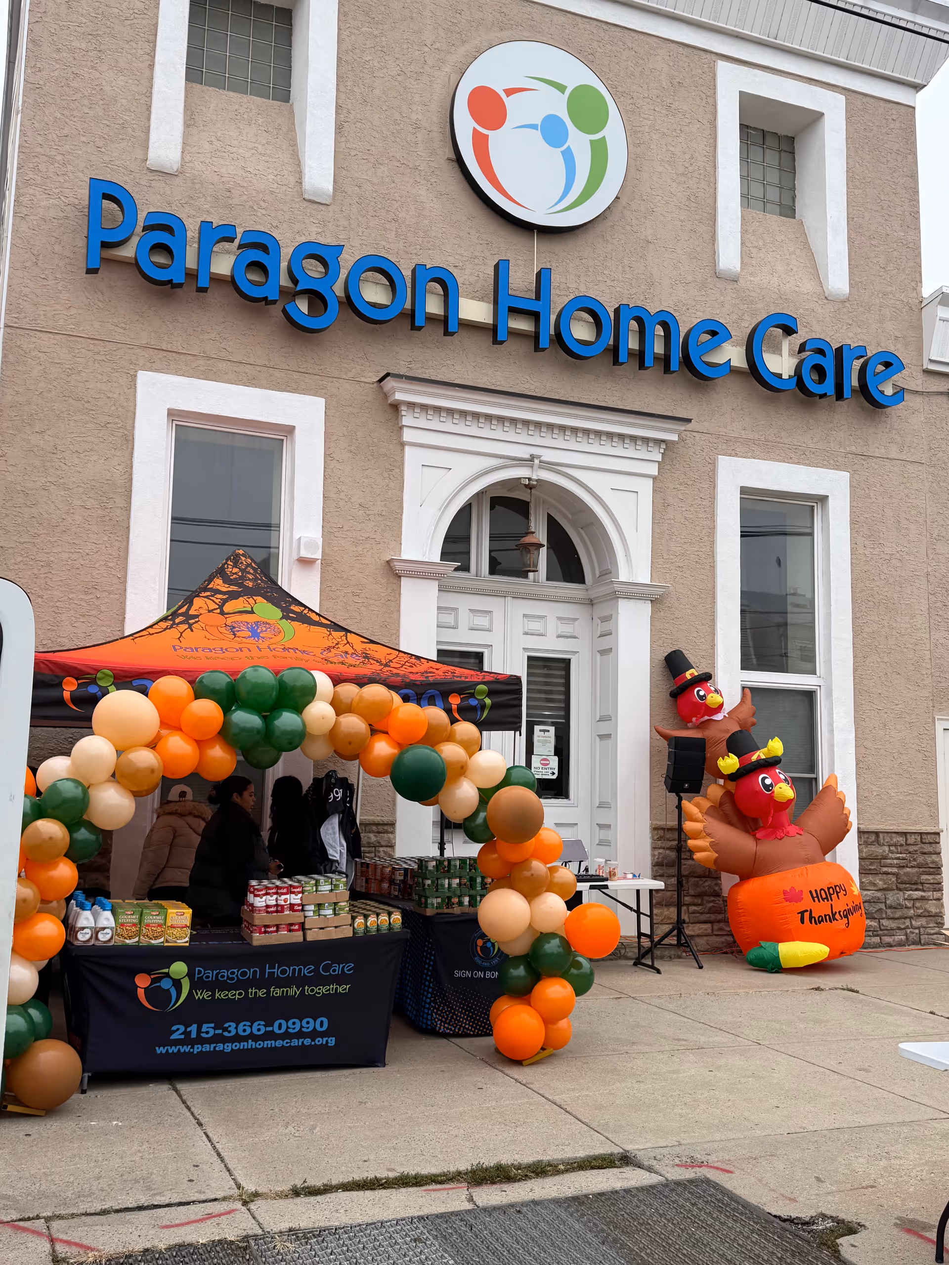 Paragon Home Care building front with balloon arch and outdoor event setup