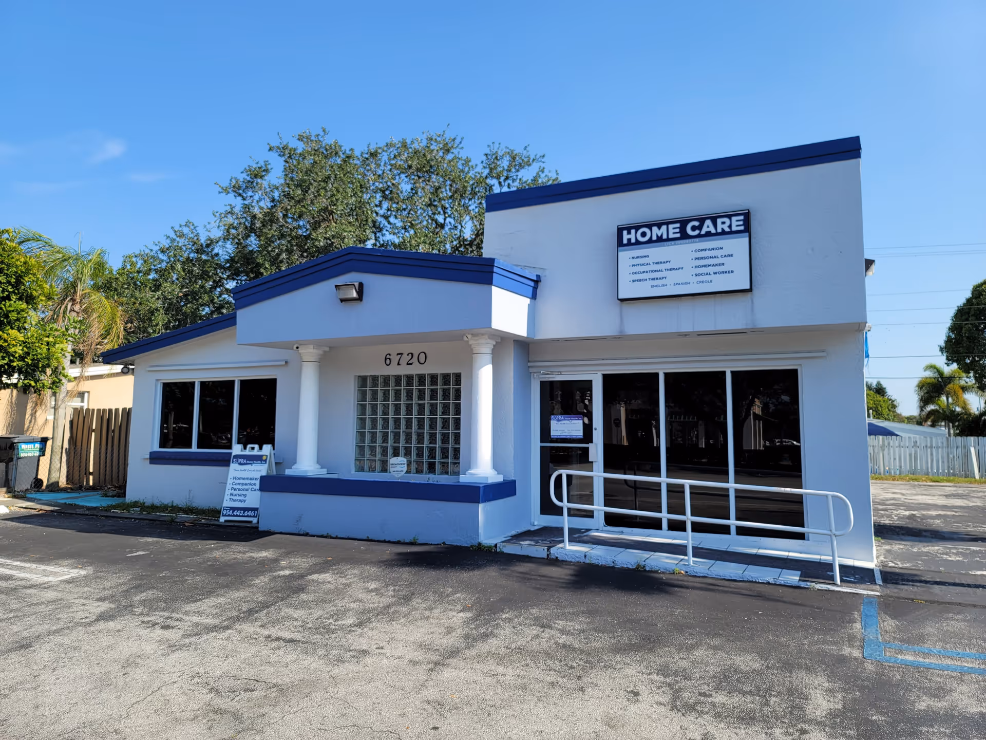 White building with blue trim labeled Home Care, street number 6720, glass entrance.