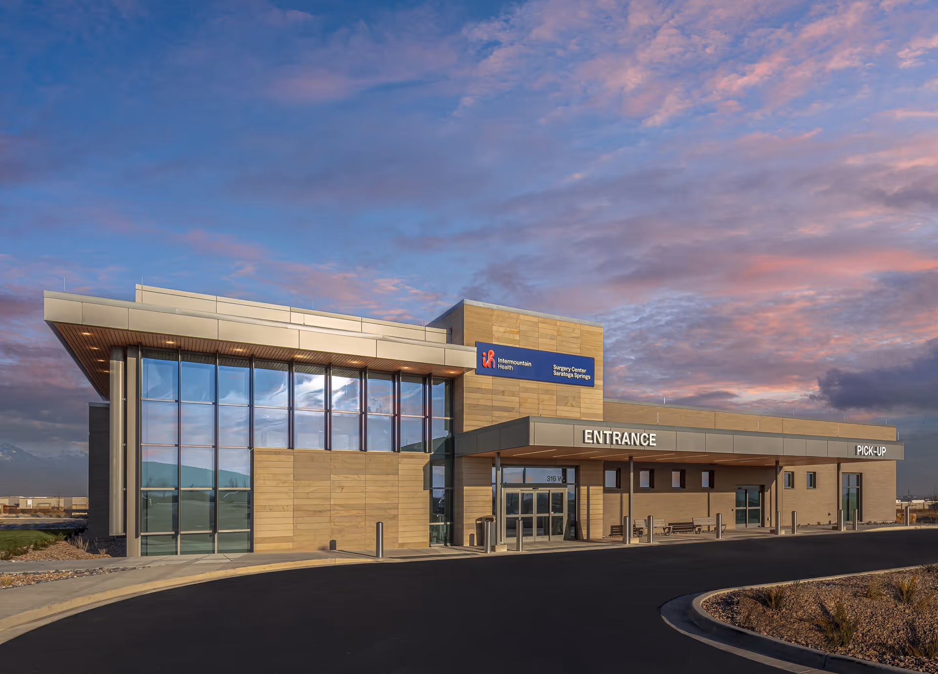 Exterior view of Saratoga Springs Surgery Center with glass facade and entrance signs.