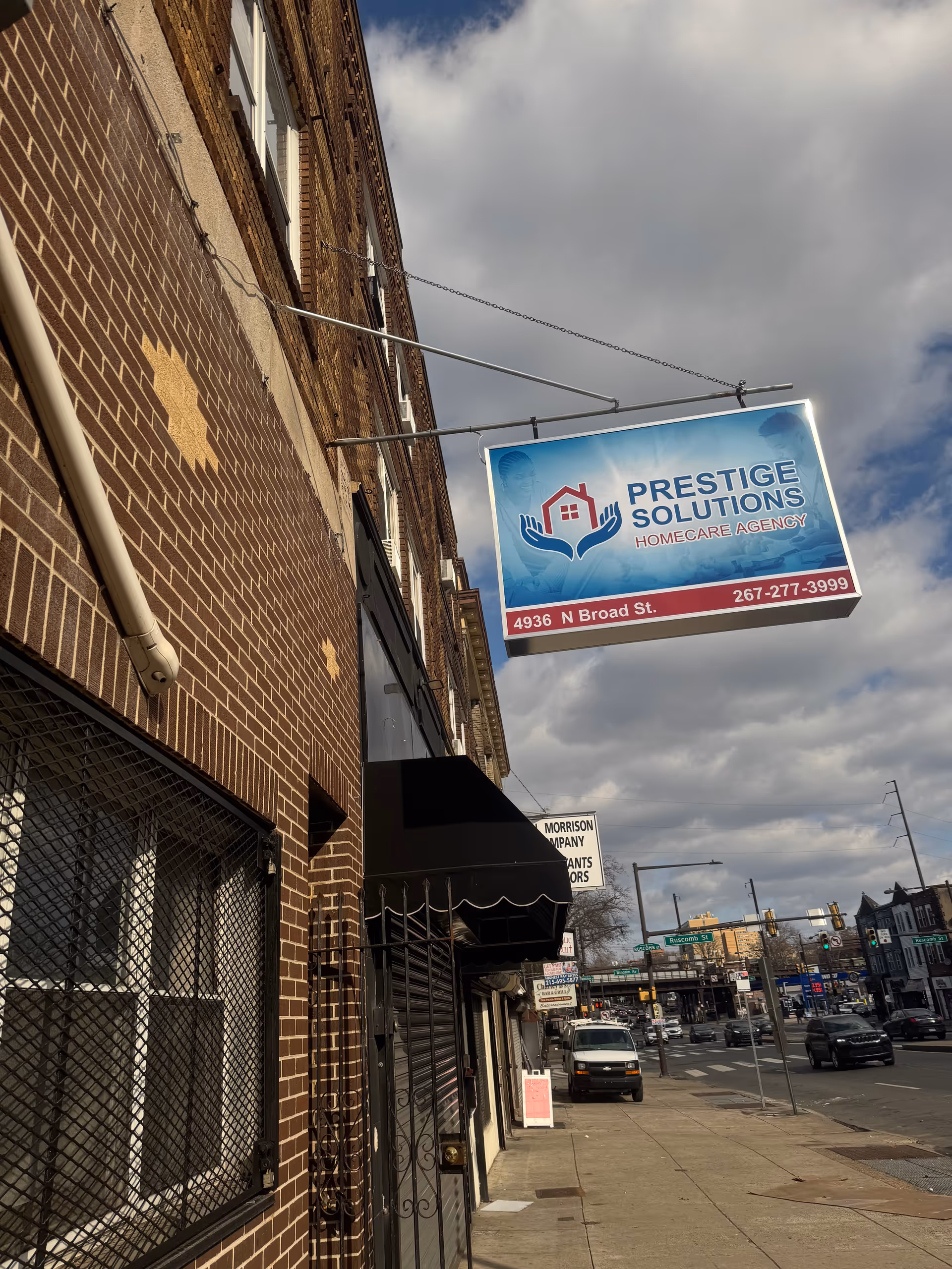 Exterior street view of a brick building with a Prestige Solutions HomeCare Agency sign.