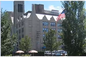 Exterior view of Boulevard Temple Care Center with flag, trees, and outdoor seating.