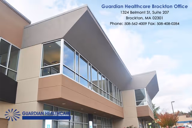 Exterior view of Guardian Healthcare building with signage and large windows in daylight.