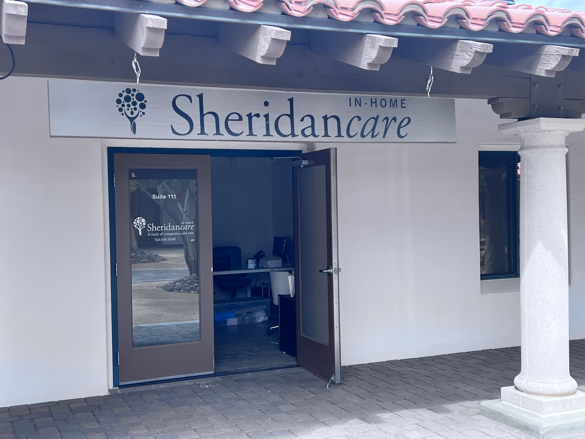 Exterior view of Sheridan Care Desert Cities entrance with open doors and visible reception desk.