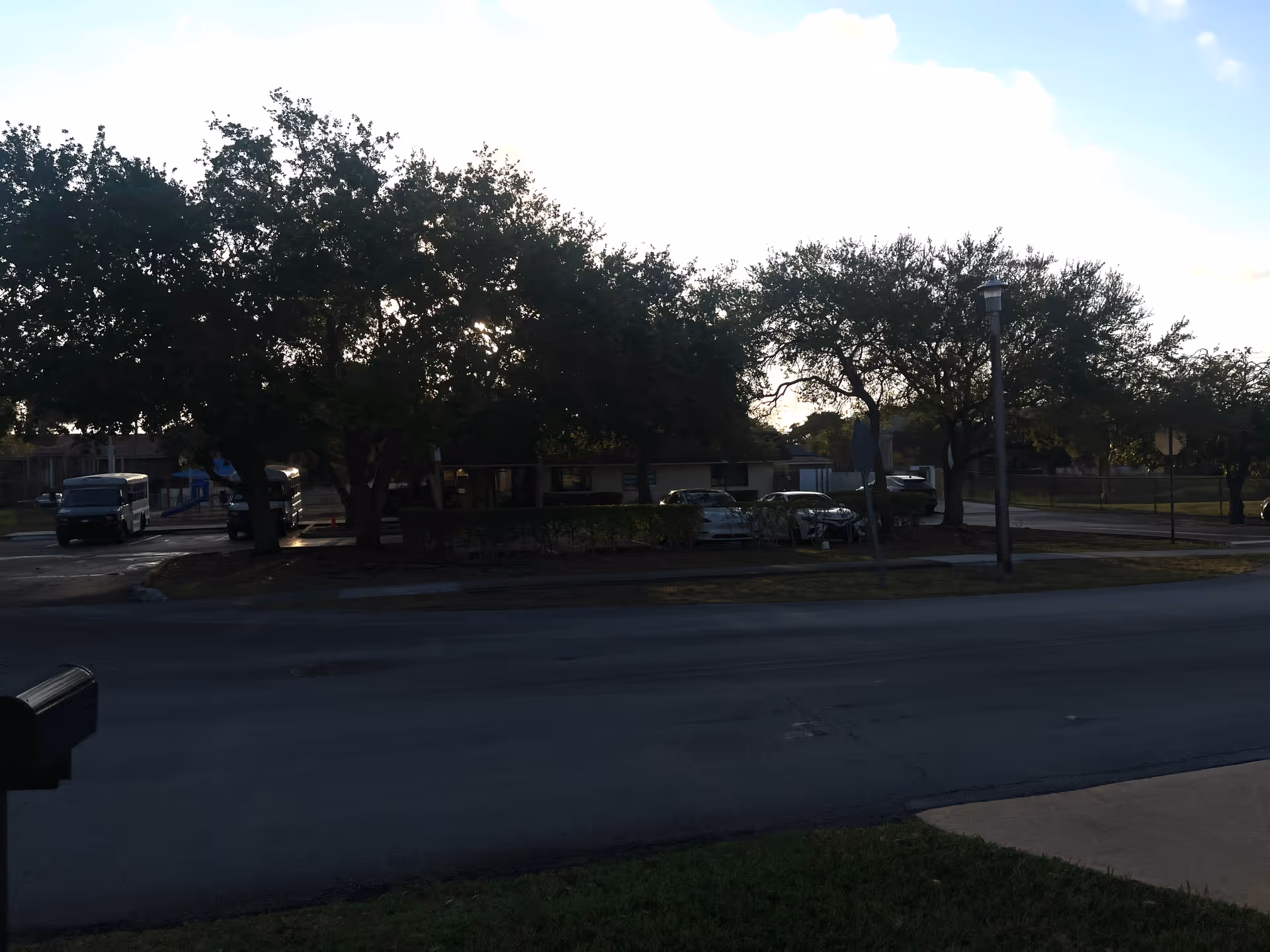 A street view shows a senior living facility front with trees and parked cars.