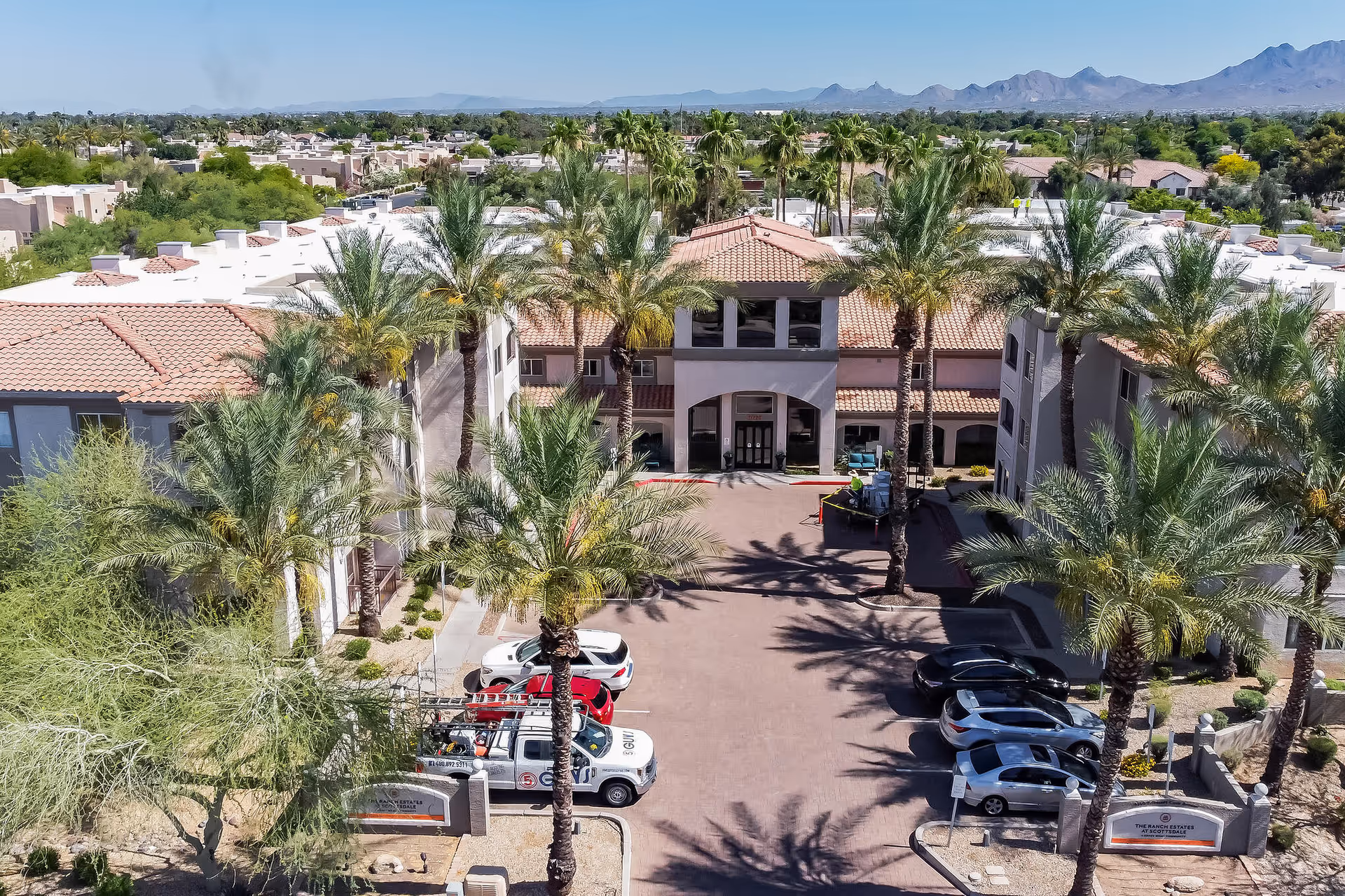 Aerial view of The Ranch Estates at Scottsdale campus with palm trees and entrance.