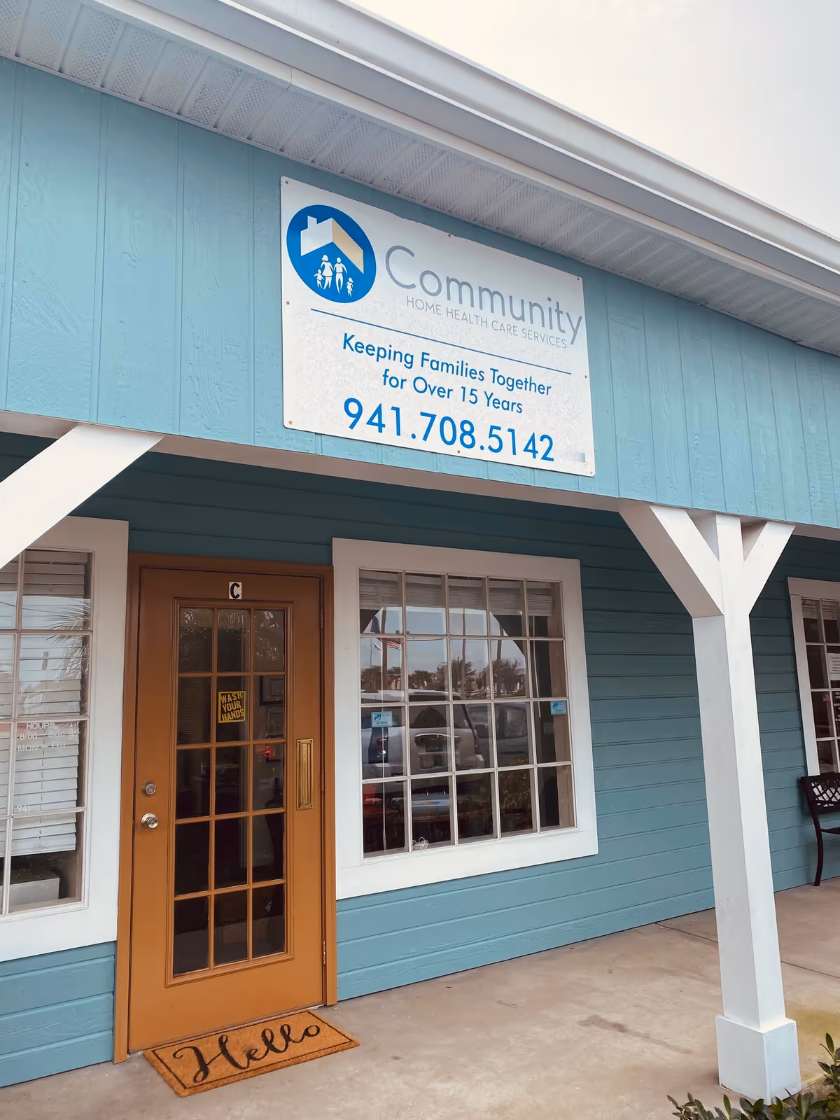 Front exterior of a teal building with a sign for Community Home Health Care Services.