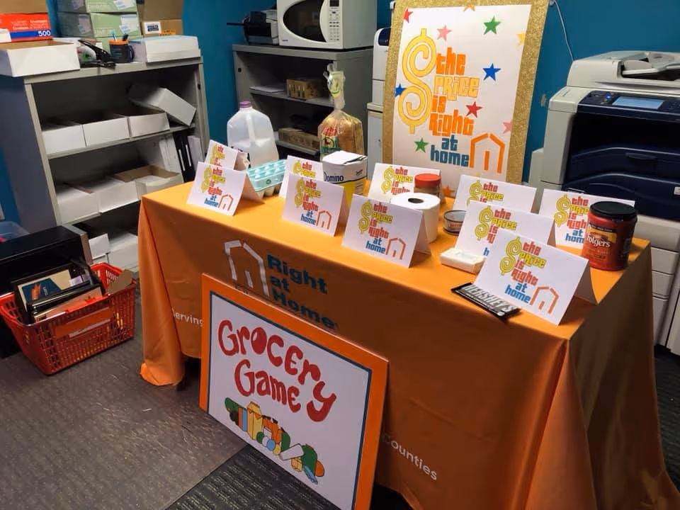 Indoor table with Right at Home branding and grocery game props.