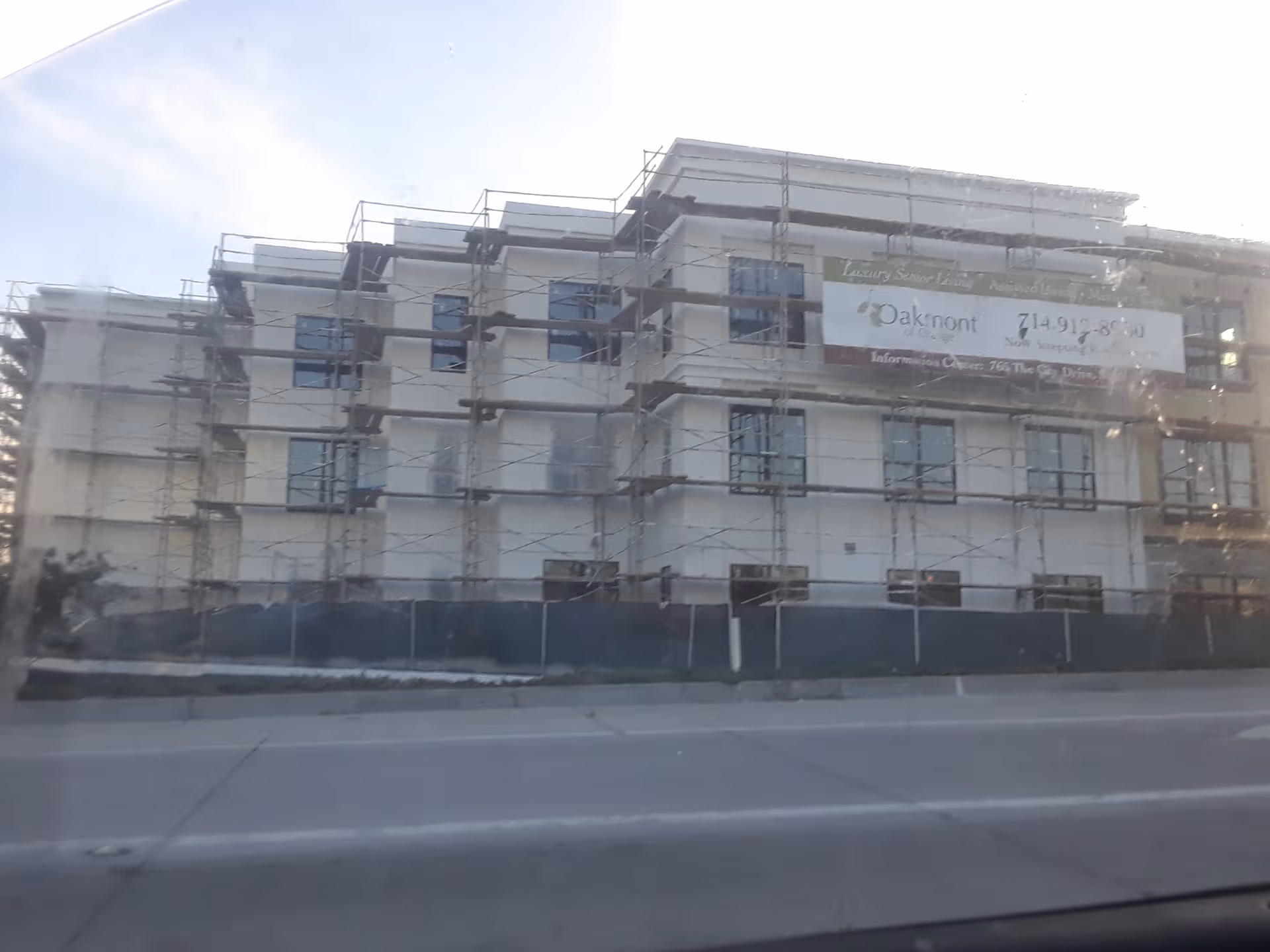 Under-construction Oakmont of Orange building with scaffolding along the exterior.