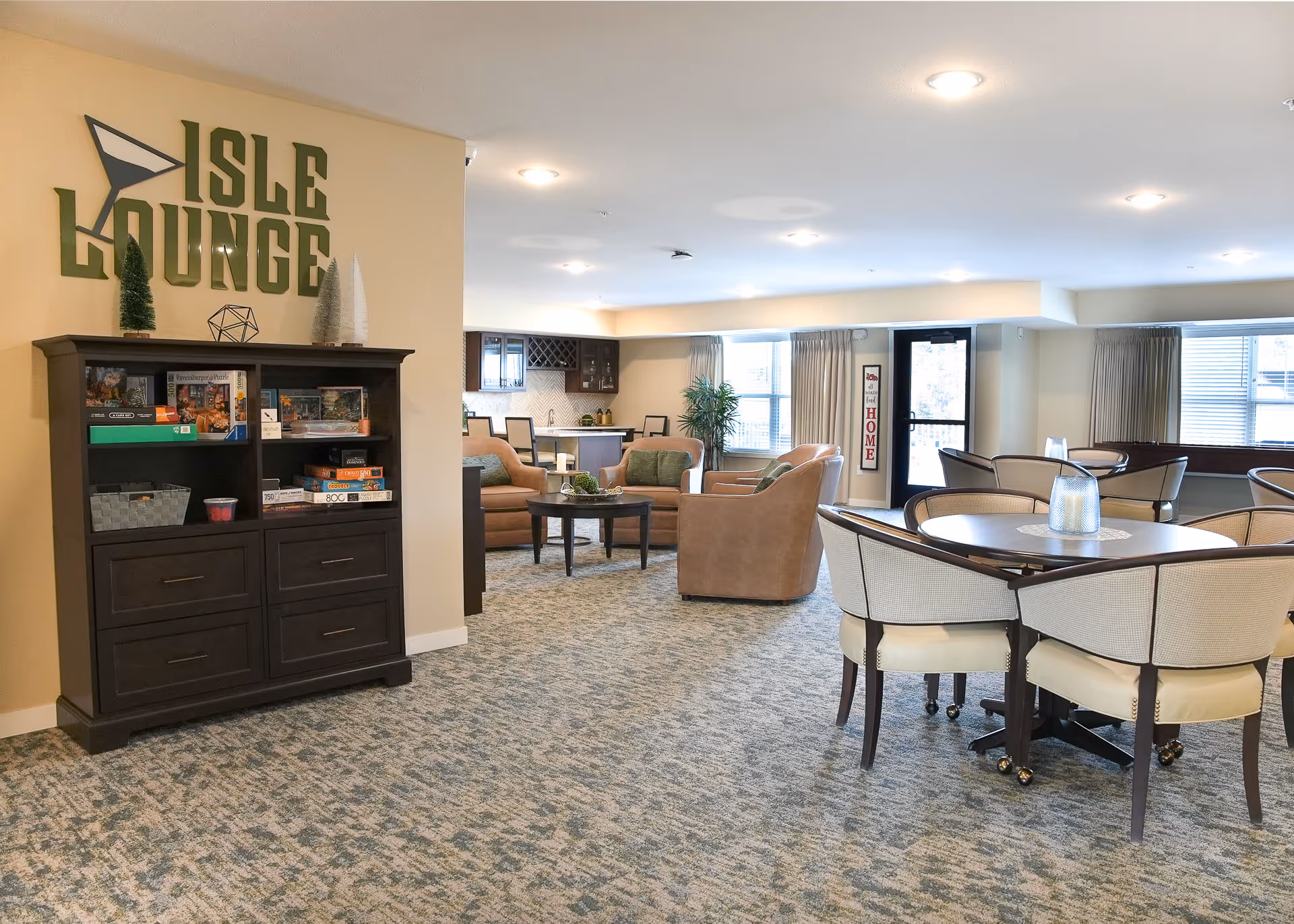 Isle Lounge interior featuring sofas, tables, and a game cabinet.
