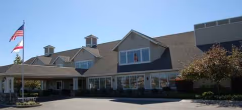 Exterior view of Brookdale Lodi senior living facility with flag, parking, and entrance
