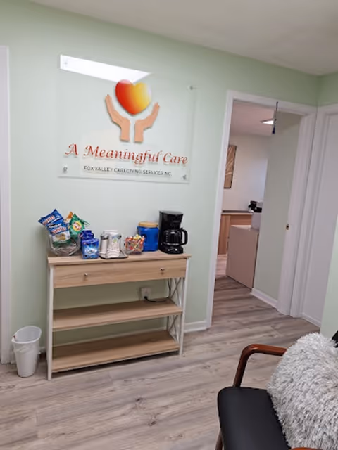 Interior reception area in a senior care facility with a snack station and Meaningful Care sign.