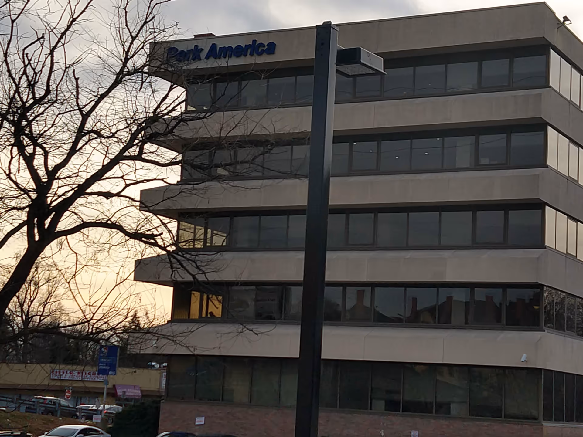 A multi-story office building with large windows and a Bank America sign along the top.