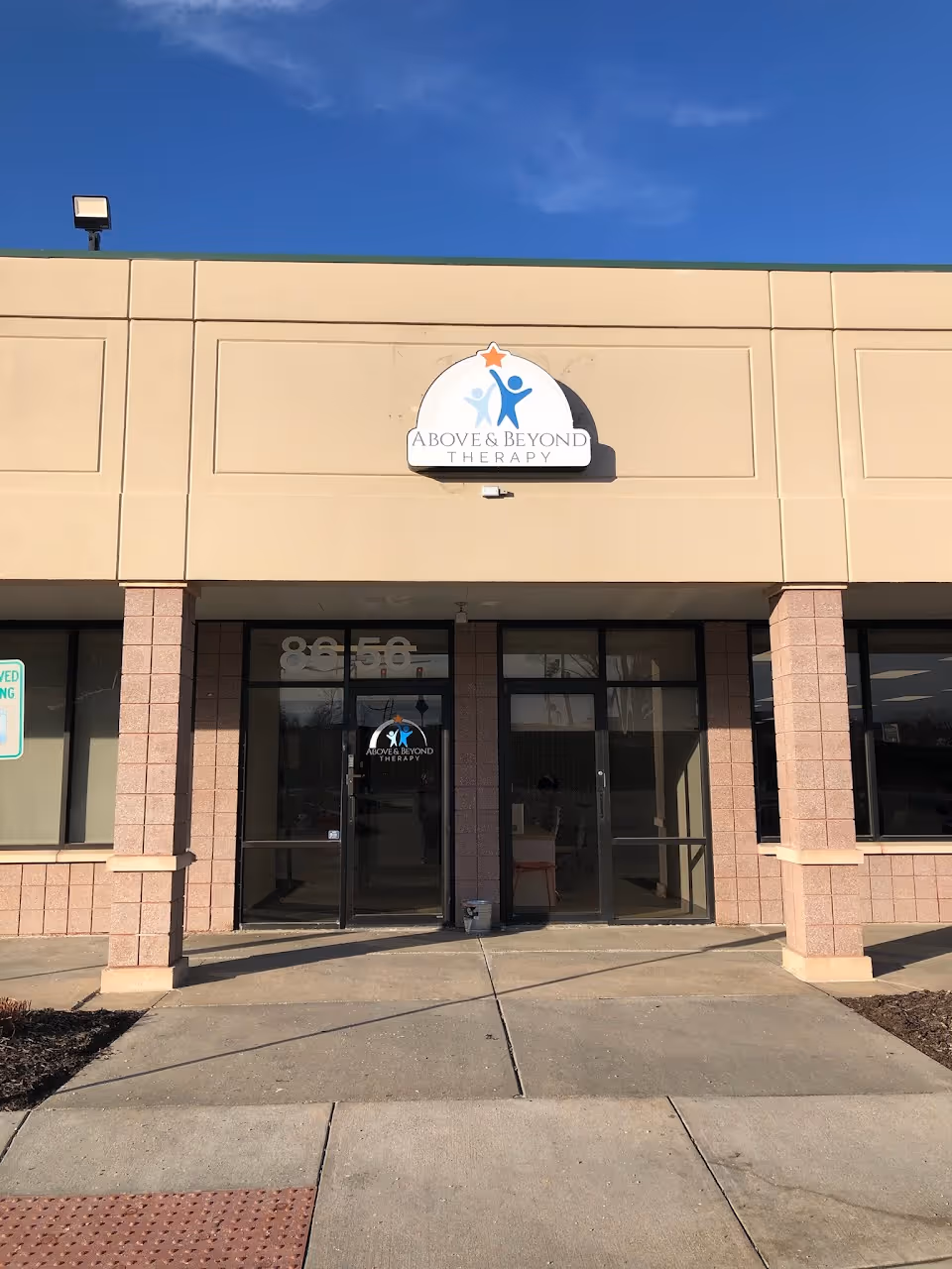 Front of Above & Beyond Therapy Center with glass doors and signage.