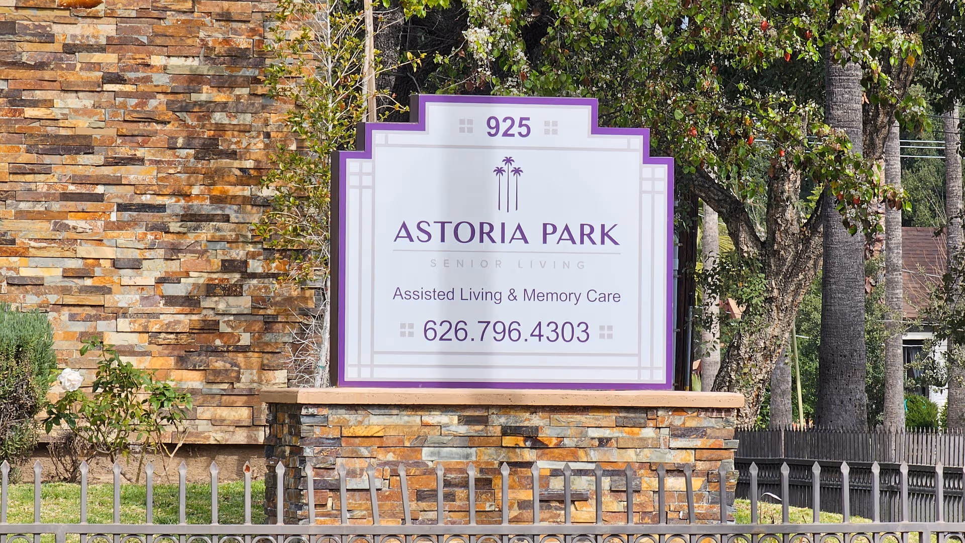 Exterior view of Astoria Park Senior Living sign at the entrance.