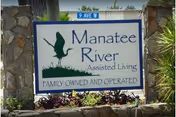 Entrance sign for Manatee River Assisted Living with stone pillars and landscaping.